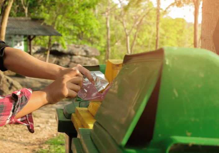 cropped-hand-woman-putting-bottl